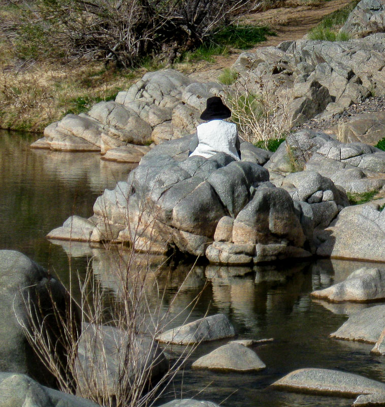 Woman resting on a large section or rocks