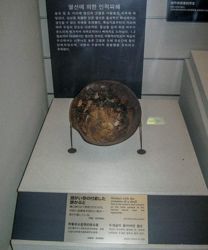Metal helmet with remains of a human skull, Nagasaki