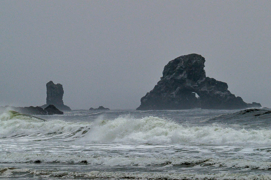 Dark, craggy rock formations just offshore