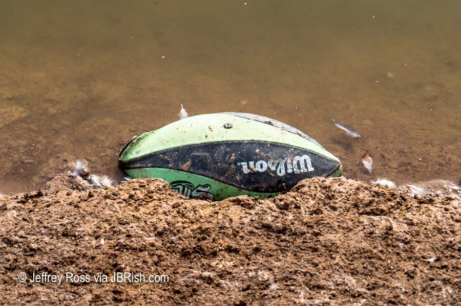 Floating lost football left behind at the ponds