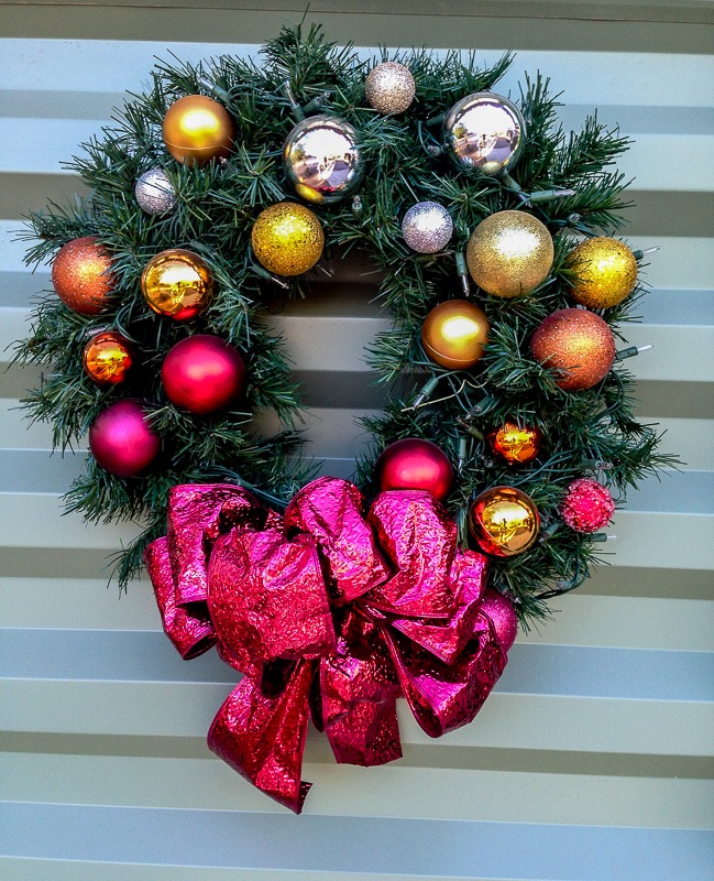 Christmas wreath with red ribbon and shiny balls