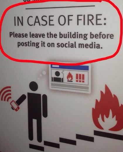 Sign - In Case of Fire, Please exit before posting on social media