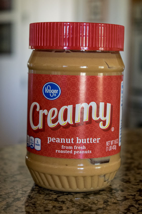 Peanut butter jar with red lid
