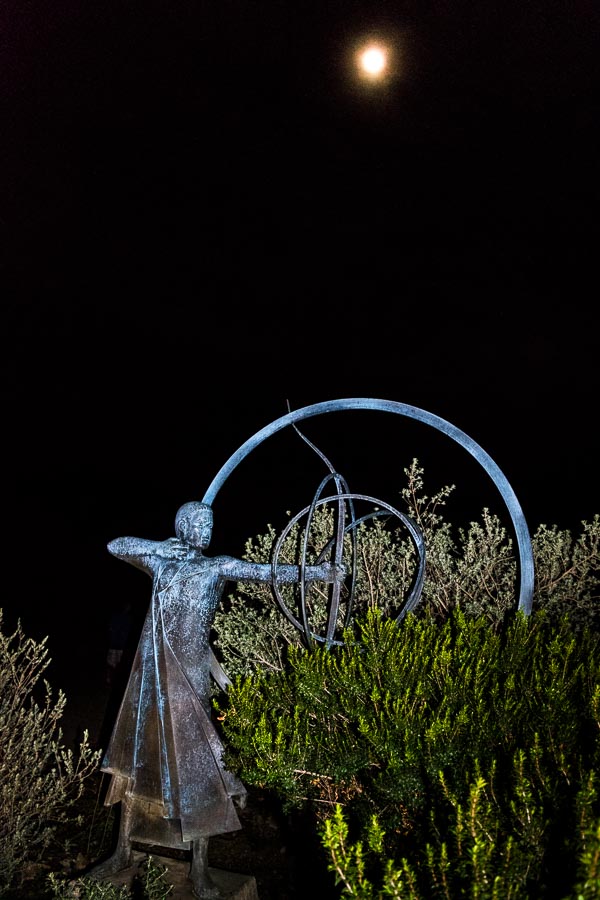 Moon over statue of archer
