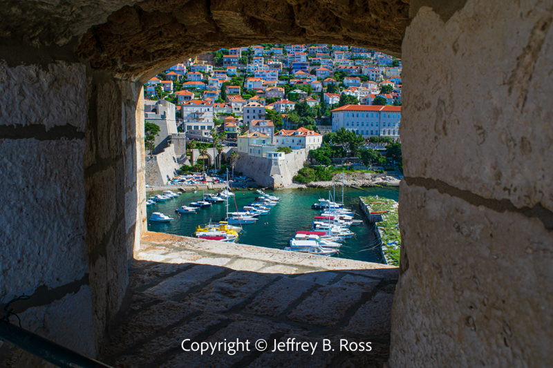 Old Town harbor viewed through a window in the wall